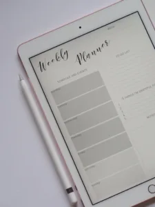 Weekly Planner template displayed on pink colored Ipad